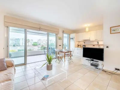 a living room with a couch and a table at Apartment Cristal Croisette-4 by Interhome in Cannes