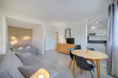 a living room with a couch and a table at Confortable Studio Calme, Latour Mauboug-CARLTON MARTINEZ A0B107 in Cannes