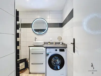 a bathroom with a washing machine and a mirror at Le Brasilia - 4 pers - 10 min Palais - Climatisé - Centre in Cannes