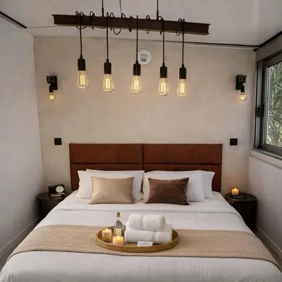 a bedroom with a large bed and a stone wall at 