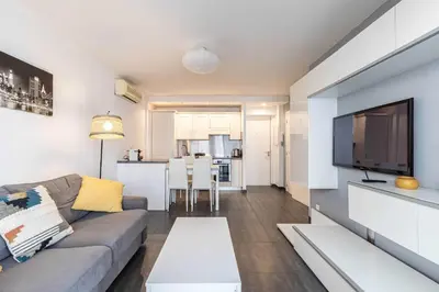 a living room with a couch and a flat screen tv at Beautiful apartment with balcony - Center Cannes in Cannes