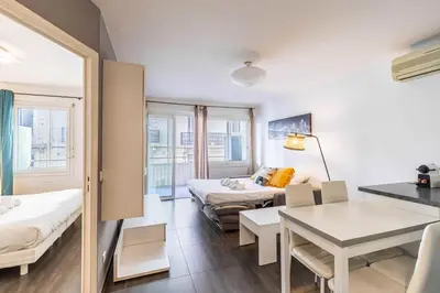 a room with a bed and a table and a couch at Beautiful apartment with balcony - Center Cannes in Cannes
