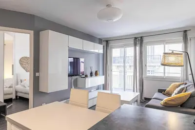 a living room with a couch and a table at Beautiful apartment with balcony - Center Cannes in Cannes