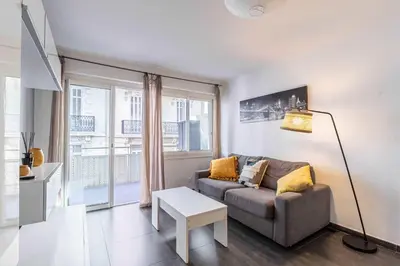 a living room with a couch and a table at Beautiful apartment with balcony - Center Cannes in Cannes