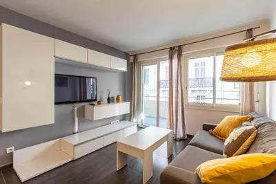 a living room with a couch and a tv at Beautiful apartment with balcony - Center Cannes in Cannes