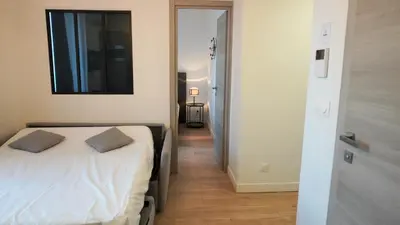 a bedroom with a bed with two pillows on it at Proche Carlton & Croisette, Appartement 301 - Palmazur Vacances in Cannes