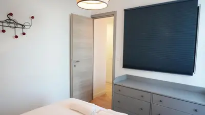 a bedroom with a large window with a blue dresser at Proche Carlton & Croisette, Appartement 301 - Palmazur Vacances in Cannes