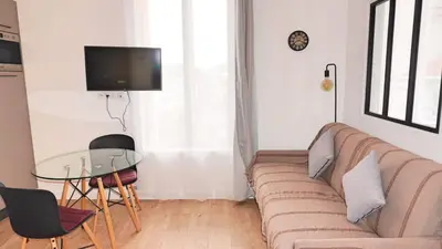 a living room with a couch and a glass table at Proche Carlton & Croisette, Appartement 301 - Palmazur Vacances in Cannes
