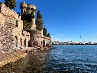 an old brick wall next to a body of water at Appartement 33 m2 comme une junior suite - vue Port et Palais des festivals in Cannes