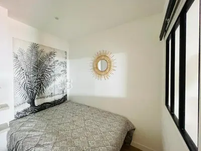 a bedroom with a bed and a mirror on the wall at F1 neuf TURCKHEIM TUR102 in Cannes