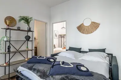 a bedroom with two beds and a mirror at Résidence Palais des Festivals - Cannes centre in Cannes