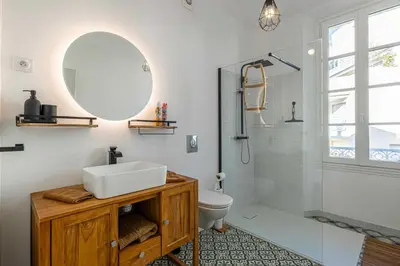 a bathroom with a sink and a toilet and a mirror at Résidence Palais des Festivals - Cannes centre in Cannes