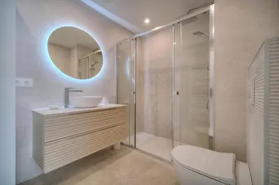 a bathroom with a toilet and a sink and a mirror at REF 1745 - Cannes Center - Studio for rent in Cannes