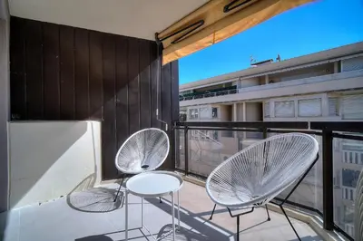 three chairs and a table on a balcony at REF 1745 - Cannes Center - Studio for rent in Cannes