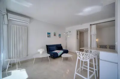 a living room with a blue couch and chairs at REF 1745 - Cannes Center - Studio for rent in Cannes