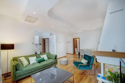a living room with a green couch and a table at REF 1320 - Cannes Center - Apartment for rent in Cannes
