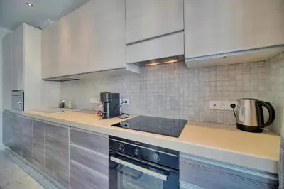 a kitchen with white cabinets and a counter top at REF 1477 - Apartment for rent in Cannes