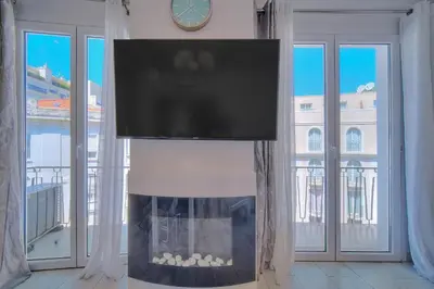 a living room with a fireplace with a tv above it at REF 1477 - Apartment for rent in Cannes