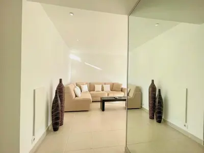 a living room with a couch and a glass wall at PR Croisette, by Welcome to Cannes in Cannes