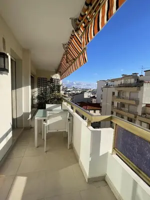 a balcony with a table and chairs on a building at PR Croisette, by Welcome to Cannes in Cannes