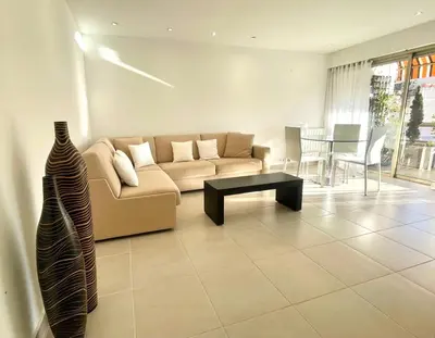 a living room with a couch and a table at PR Croisette, by Welcome to Cannes in Cannes