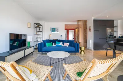 a living room with a blue couch and chairs at Palais Azur in Cannes