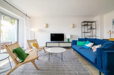 a living room with a blue couch and chairs at Palais Azur in Cannes