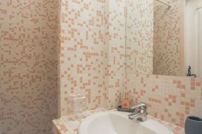 a bathroom with a sink and a mirror at Studio Mimosa - Welkeys in Cannes