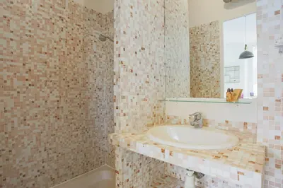a bathroom with a sink and a mirror at Appartement Palme d'Or - Welkeys in Cannes