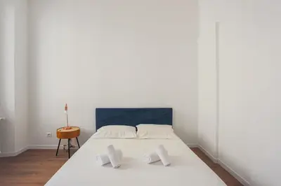 a bedroom with a white bed with two pillows at Appartement Palme d'Or - Welkeys in Cannes