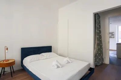 a bedroom with a white bed and a table at Appartement Palme d'Or - Welkeys in Cannes