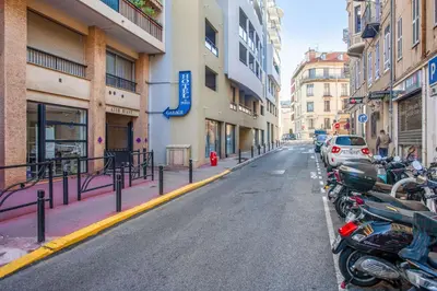 a row of motorcycles parked on the side of a street at Studio Merle - Welkeys in Cannes