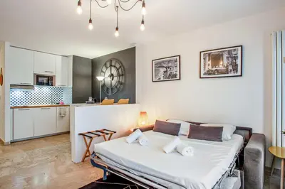 a bedroom with a large bed in a room at Studio Merle - Welkeys in Cannes