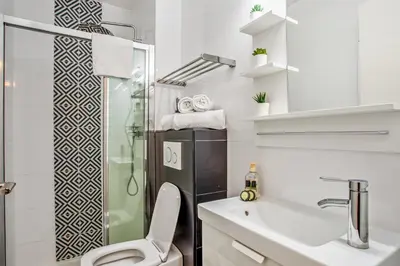 a bathroom with a shower and a toilet and a sink at Studio Merle - Welkeys in Cannes