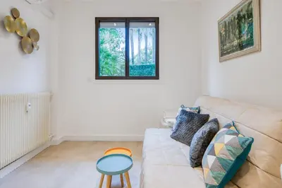 a living room with a couch and a table at Studio Lys - Welkeys in Cannes
