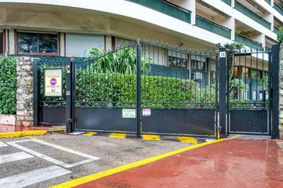 a gate in front of a building with plants at Studio Lys - Welkeys in Cannes