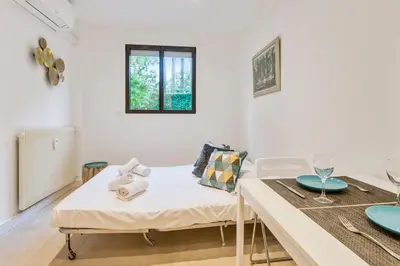 a living room with a table and a couch at Studio Lys - Welkeys in Cannes