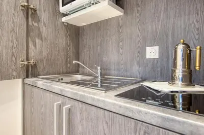 a kitchen with a sink and a microwave at Studio Lys - Welkeys in Cannes