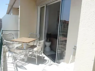a patio with a table and chairs on a balcony at Two bedroom apartment next to the Croisette in Cannes a short walk to the Palais des Festivals - 1961 in Cannes