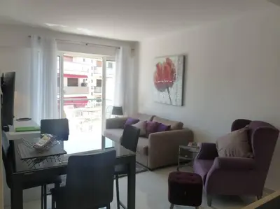 a living room with a couch and a table at Two bedroom apartment next to the Croisette in Cannes a short walk to the Palais des Festivals - 1961 in Cannes