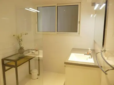 a white bathroom with a sink and a mirror at Two bedroom apartment next to the Croisette in Cannes a short walk to the Palais des Festivals - 1961 in Cannes