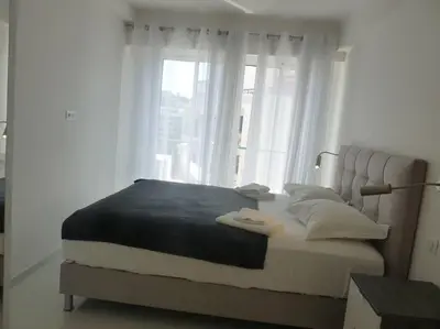 a bedroom with a large bed with a window at Two bedroom apartment next to the Croisette in Cannes a short walk to the Palais des Festivals - 1961 in Cannes