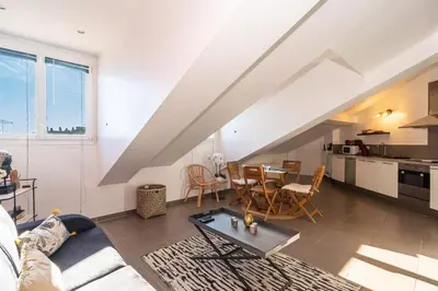 a living room with a couch and a table at Le Laeti - 600m plage - Verrière Côte d'Azur in Cannes