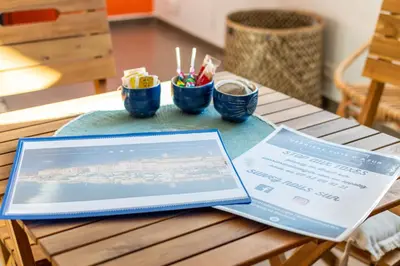 a laptop computer sitting on top of a wooden table at Le Laeti - 600m plage - Verrière Côte d'Azur in Cannes