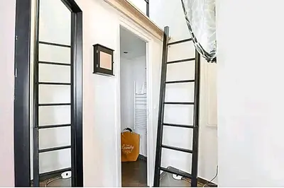 a ladder leading to a room with a mirror at Le Laeti - 600m plage - Verrière Côte d'Azur in Cannes
