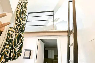 a stairwell with a glass railing on a house at Le Laeti - 600m plage - Verrière Côte d'Azur in Cannes