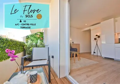 a living room with a table and a sign that reads le home siss ne at Le Flore - Appartement neuf - Cannes Center in Cannes