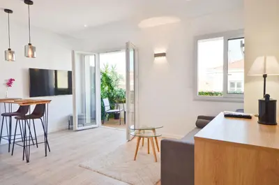 a living room with a couch and a table at Le Flore - Appartement neuf - Cannes Center in Cannes