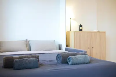 a bedroom with a bed with two towels on it at Le Flore - Appartement neuf - Cannes Center in Cannes