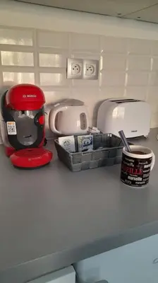 a red coffee maker sitting on top of a counter at Appartement proche croisette avec parking et climatisation in Cannes